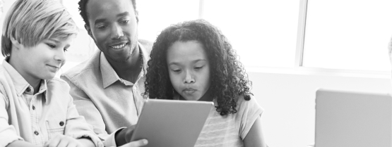 Parents and child looking at laptop